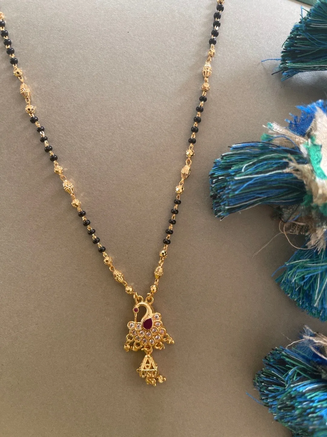 Artificial American Diamond Short Gold Mangalsutra Designs Peacock Pendant Gold & Black Beads Chain
